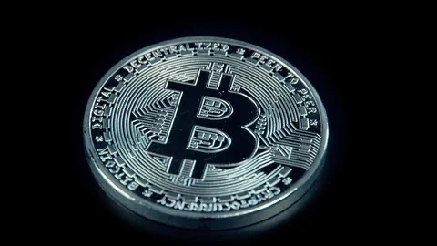 SIlver Bitcoin coin on black background. Silver Crypto coin on spinning stand. Stock Footage 126907783