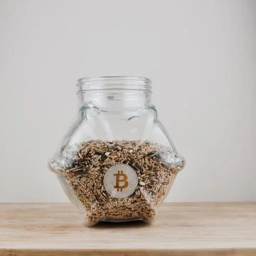 Silver bitcoin coin in jar Stock Photos
