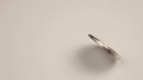 A silver bitcoin coin spins on a white background Stock Footage 120145341