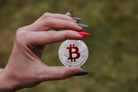 Silver bitcoin in hand Stock Photos