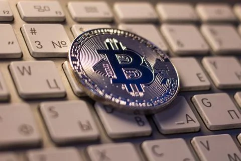 Silver bitcoin on keyboard Stock Photos