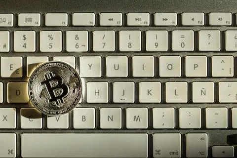 Silver bitcoin in keyboard Stock Photos