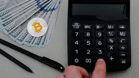 Silver bitcoin with many dollars on the working table and calculator Video stock 88224368