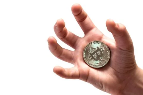 Silver bitcoin in the shrinking palm of a guy. Isolated. Stock Photos