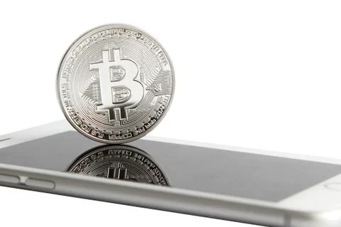 Silver bitcoin is on the smartphone Stock Photos