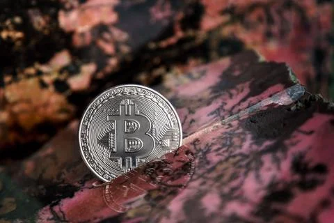 Silver bitcoin in the stone Stock-Fotos