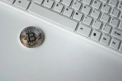 Silver bitcoin on the table. Symbol of crypto currency. Virtual currency. BTC. Stock Photos