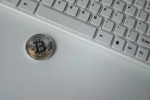 Silver bitcoin on the table. Symbol of crypto currency. Virtual currency. BTC. Stock Photos