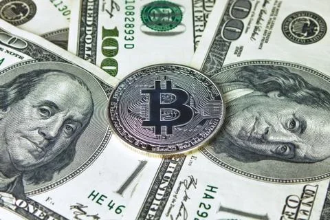 Silver Bitcoins on US dollars. Electronic money Stock Photos