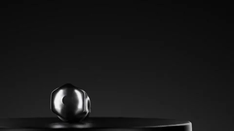 Silver Black Bolt Resting on Smooth Black Surface Under Soft Lighting Stock Footage 320245701