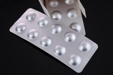Silver blister pack of small pills Stock Photos