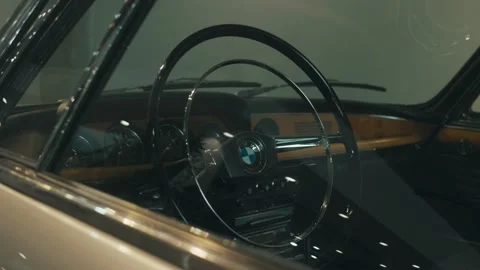 Silver BMW e9 coupe’s side window and cabin, showcasing the rounded Video stock 308924489