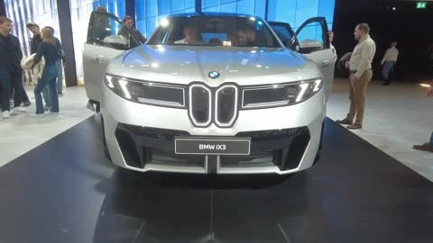 Silver bmw ix3 electric suv perspective both doors open prominent illuminated Stock Footage 328207559