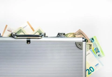 A silver briefcase, partially open, with US dollar bills and euro bills spi.. Stock Photos