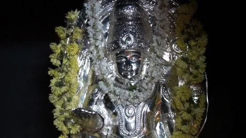 Silver bust of an Indian deity with a flower garland Stock Footage 94932939