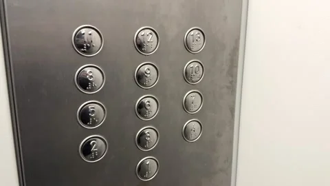 Silver buttons in the elevator for calling floors with red LED light in a Stock Footage 306124327
