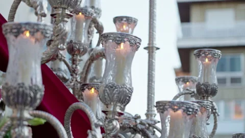 Silver candelabra with lit candles during Holy Week procession Stock Footage 333916003
