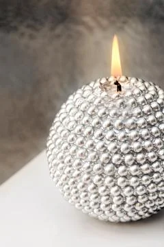 Silver candle is burning Stock Photos