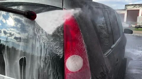 Silver car being washed at a self-service car wash Stock Footage 307053385