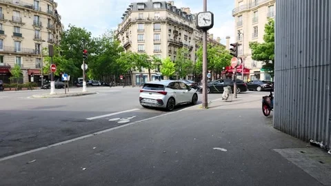Silver Car Driving Through a Paris Intersection Stock Footage 335194680