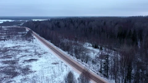 Silver car on a forest winter road. 動画素材 146263294