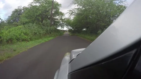 Silver Car Point Of View Driving On A Secluded Narrow Road  Stockbeeldmateriaal 83520197