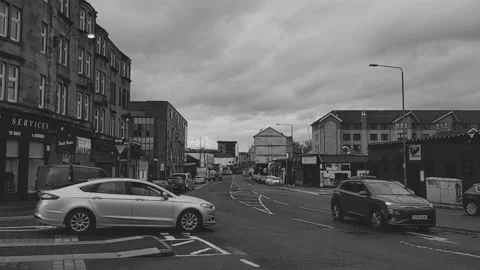 A silver car pulling out from a junction on a city road Stock Footage 171835550