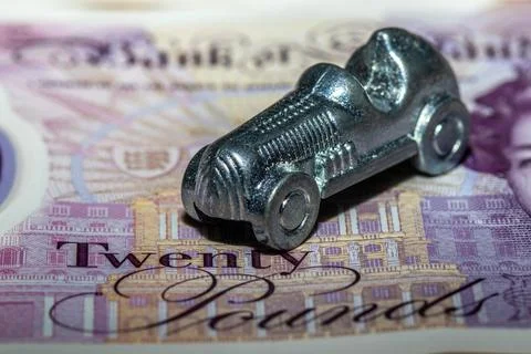 Silver Car Token on Twenty Pound Banknote Stock Photos