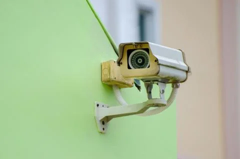 Silver CCTV Camera on the green wall Closed Circuit Television camera on gree Stock Photos