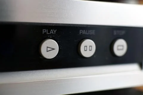 Silver CD-player control buttons on black closeup photo Stock Photos