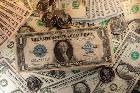 Silver Certificate Dollar banknote on new Dollar bills and coins. Stock Photos