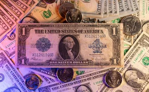 Silver certificate one Dollar banknote on top of Dollar coins and new USD Stock Photos