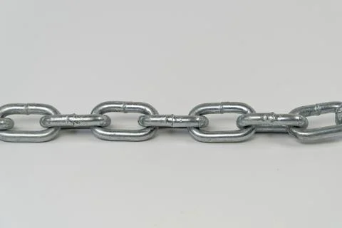 Silver chain  laid on the ground with isolated on white background Stock-Fotos