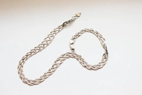 Silver chain located on a white background Stock Photos