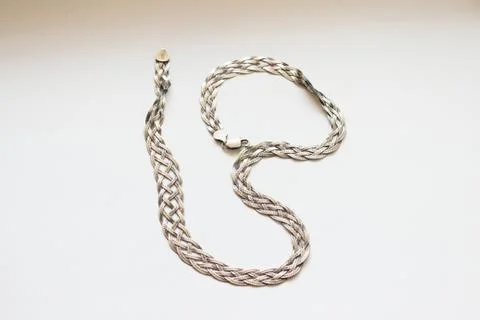 Silver chain located on a white background Stock Photos