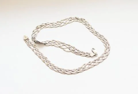 Silver chain located on a white background Stock Photos