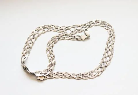 Silver chain located on a white background Stock Photos