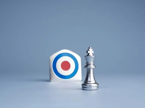 Silver chess king positioned beside target symbolizes strategic leadership,.. Stock Photos