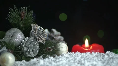 Silver Christmas Decorations With Burning Red Christmas Candle Video stock 119233584
