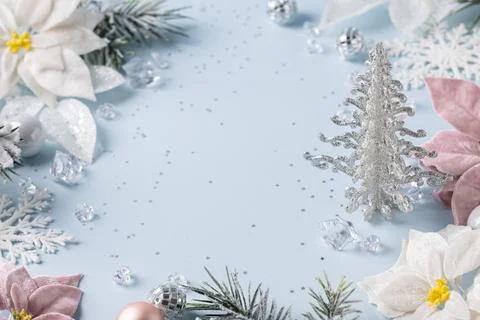 Silver Christmas tree framing blue background with poinsettias crystals and.. 스톡 사진