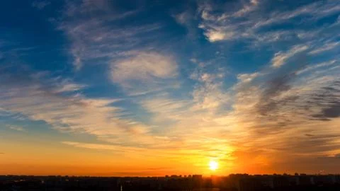 Silver clouds  and sun over houses Foto stock