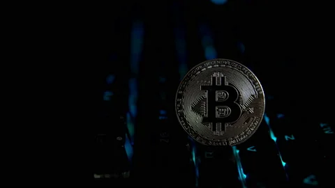 Silver coin bitcoin on the background of a flashing keyboard. Stock Footage 87597192