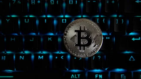 Silver coin bitcoin on the background of a flashing keyboard. Stock Footage 88276343