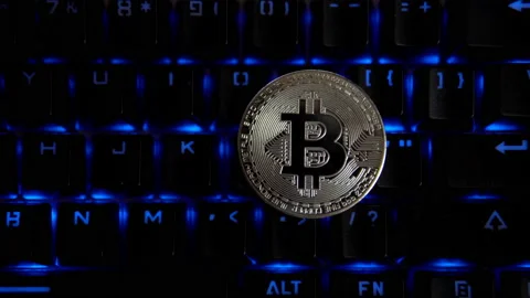 Silver coin bitcoin on the background of a flashing keyboard. Stock Footage 88276412