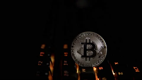 Silver coin bitcoin on the background of a flashing keyboard. Stock Footage 88276737