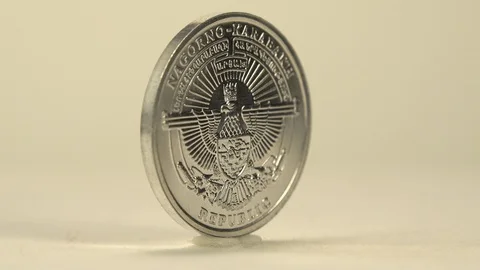 A Silver Coin Is Rotating That Has A Man On One Side And An Object On The Other Video stock 129783378
