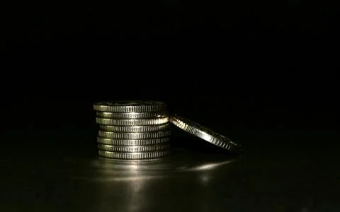 Silver coin stack isolated on a black background. Space for text Stock-Fotos