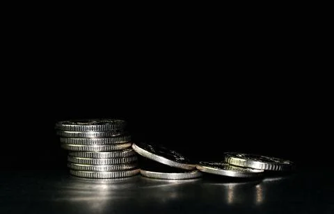 Silver coin stack isolated on a black background. Space for text Stock-Fotos