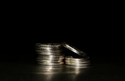 Silver coin stack isolated on a black background with reflection. Space for t Stock-Fotos