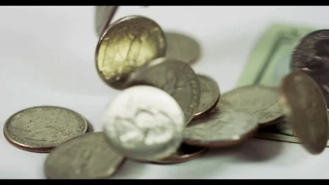 Silver coins falling spinning on white surface near money Stock Footage 329595975